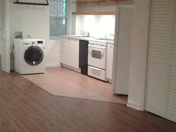 Washer/dryer in unit, hanging pot rack, microwave and coffee maker also included. Open shelving.