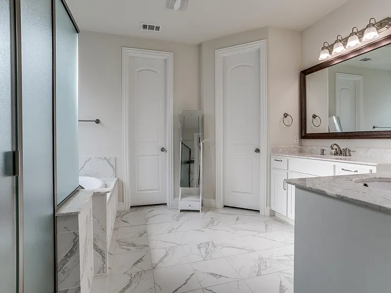 Bathroom featuring vanity, tile floors, and a bath to relax in