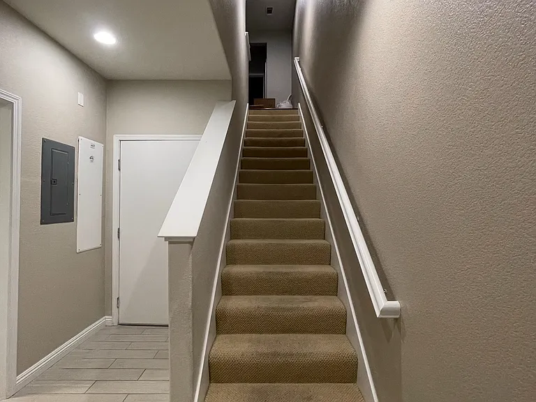 1st Floor - view is from the front door looking at the stairway leading to 2nd floor. The door shown in the picture is the door leading to the 2 car garage which has EV charging, washer/dryer