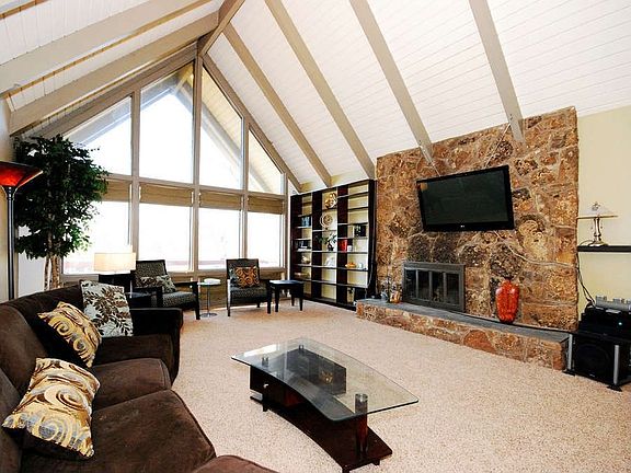 "Floor to ceiling windows in the vaulted living room frames a perfect view of Pikes Peak."