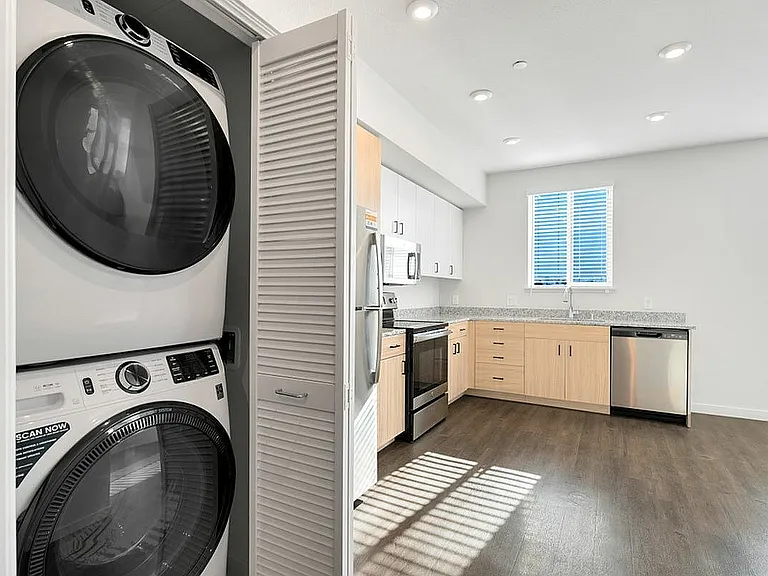 Bright and inviting kitchen with convenient laundry facilities, perfect for urban living.