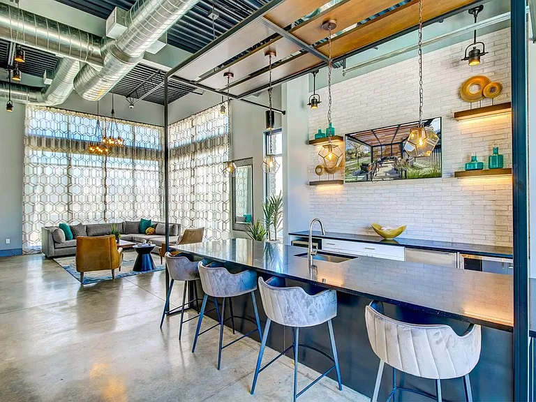 Resident's clubhouse with entertaining kitchenette, flat-screen television, billiards, and more