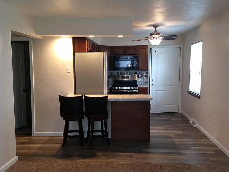 BEAUTIFUL SETTING FROM THE OPEN KITCHEN INTO THE LIVING ROOM COMES WITH 2 BAR STOOLS.