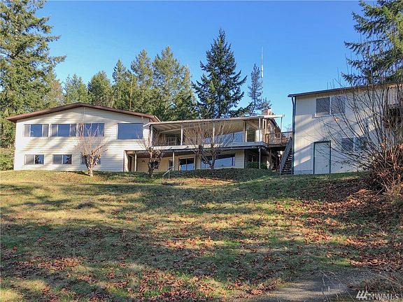 View from the West looking at the home toward the East.  There's a detached two-car garage with guest room above.