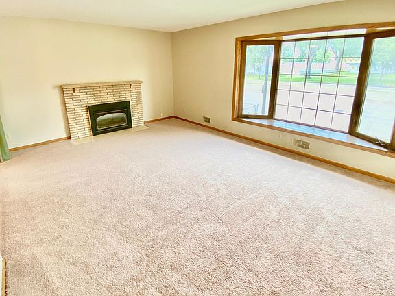 Large living room with bay window and fireplace.