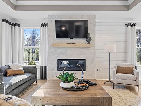 The elegant gathering room exudes timeless charm, adorned with plush furnishings, soft lighting, and