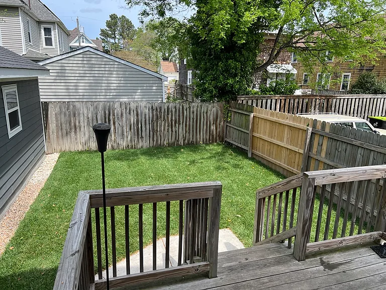 Backyard fully fenced with back porch