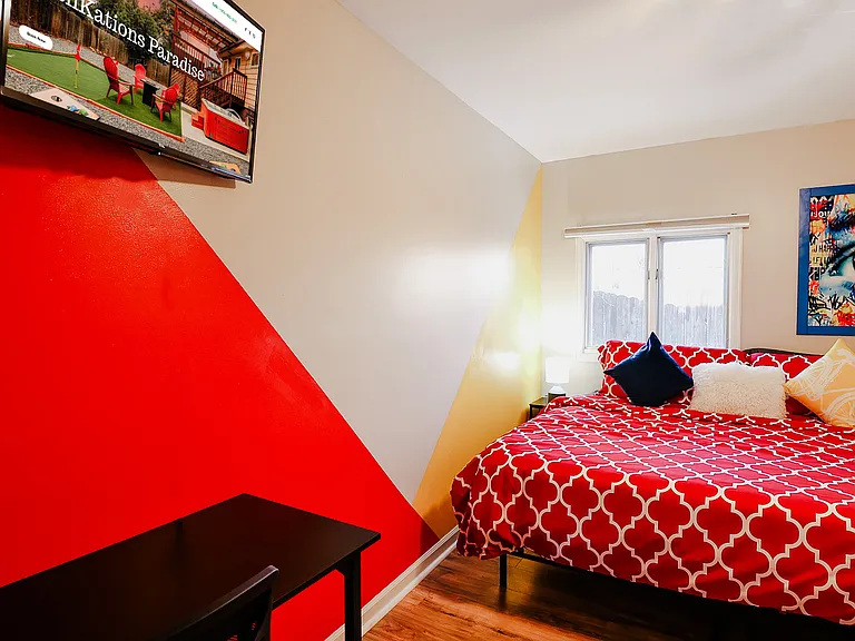 A room thoughtfully equipped with a TV for relaxation and a study table for work or study, blending entertainment and productivity seamlessly.