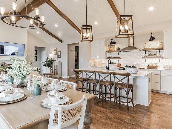 Kitchen with pendant lighting, vaulted ceiling and stained ceiling beams