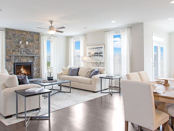 Family Room with fireplace and 4 large windows in a DRB Homes Cypress II home plan at Huntfield.