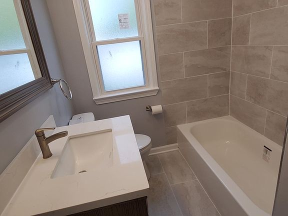 Luxury describes your new bathroom. Every detail is new from the tub, the shower, the toilet, and the quartz-topped vanity