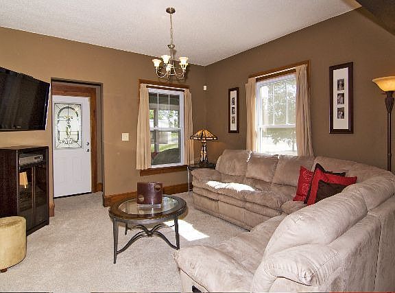 Beautiful living room with new lighting, front door.