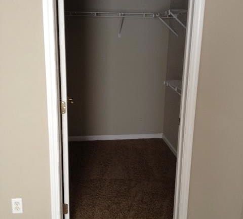 Master bedroom walk-in closet with custom organizers