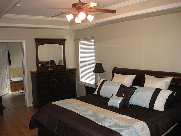 Large master bedroom with tray ceiling, also has wall mounted flatscreen.  