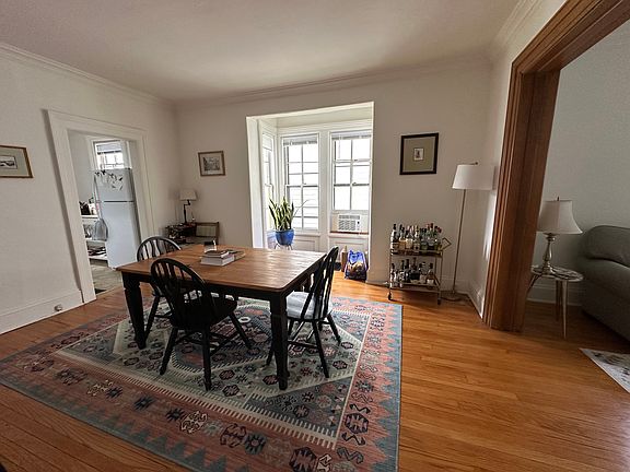 Dining room with bow window providing lots of natural light. Window air conditioner provided.