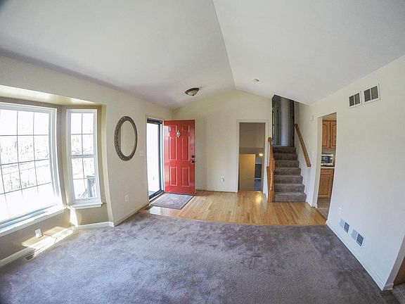 Entrance living room area. Hardwood leads into kitchen