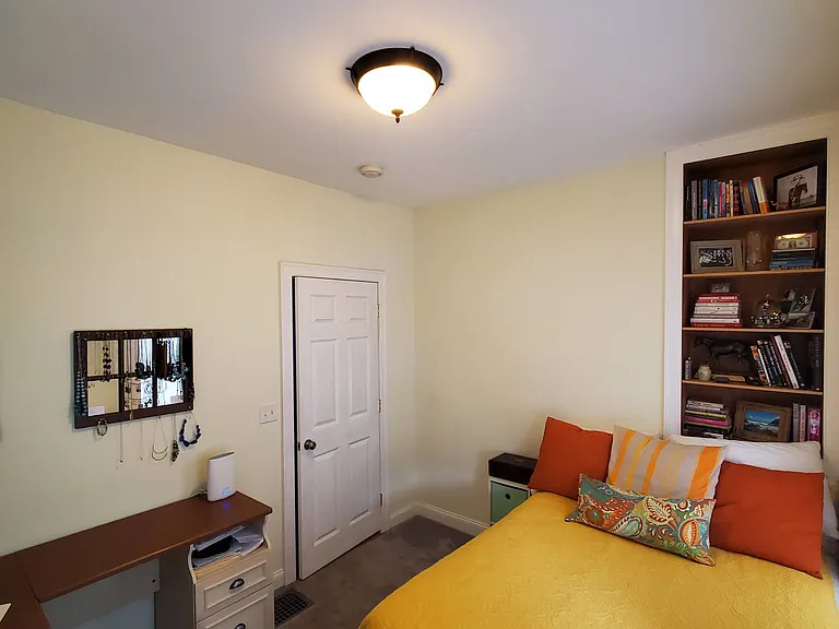 Bedroom 3 with a full bed, built in shelves, and desk