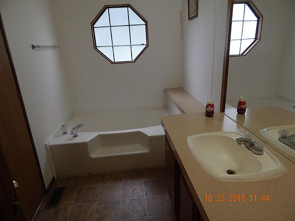 Master bath showing garden tub, sink and vanity.