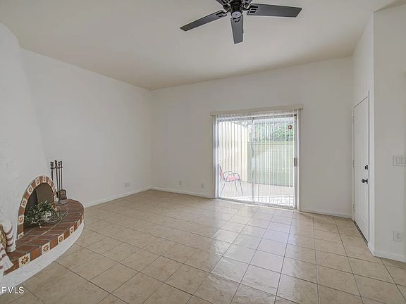 Living room. Sliding glass doors open to front porch.