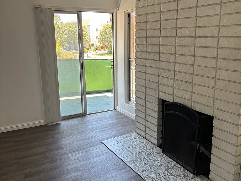 Fireplace and entrance to balcony.