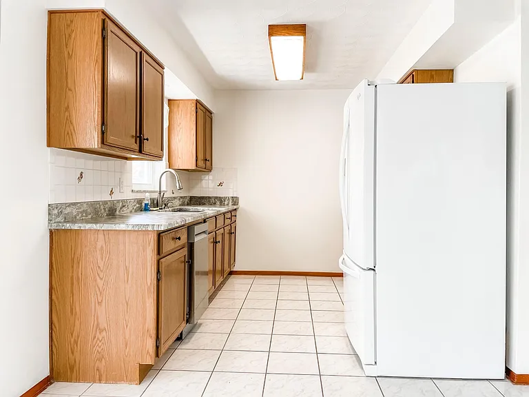 Galley-style kitchen with brand new granite countertops! Large refrigerator purchased recently as well.