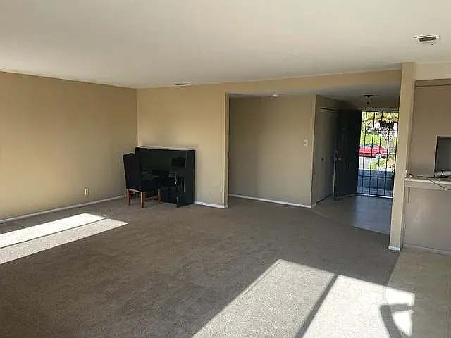 View of Entry & Living Room from Fireplace/Rear