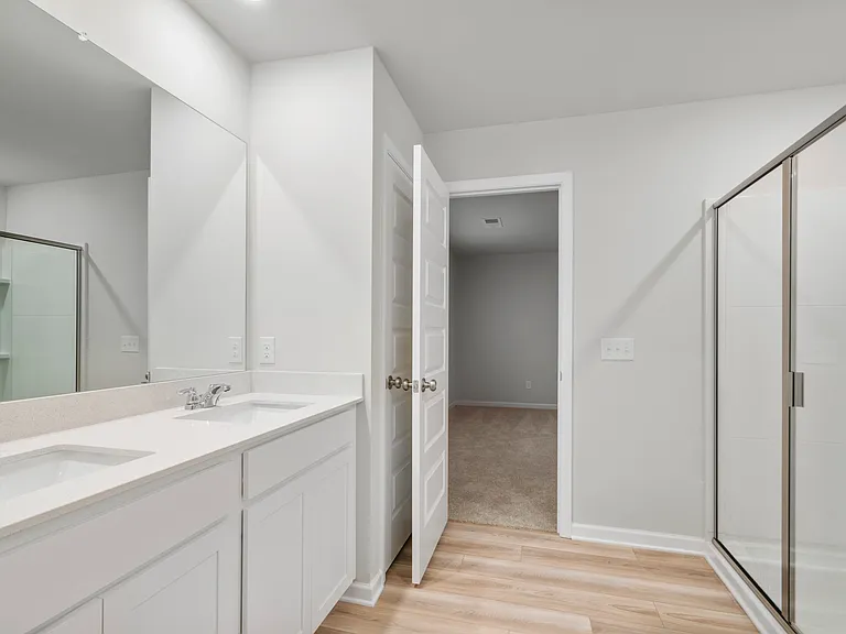 Large shower and double vanities.