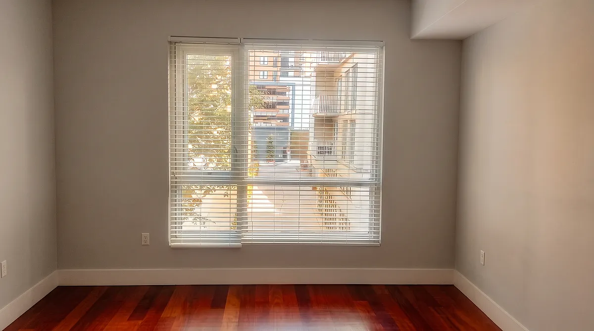 Living room with large window overlooking 12th Street - 111 N 12th St #1323A