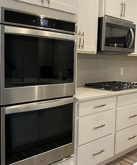 Double self cleaning ovens and built in microwave, gas cook top.