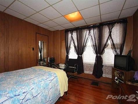 This room is used by the seller for her master bedroom.  It has original wood floors, a large walk in closet and a replacement windows.