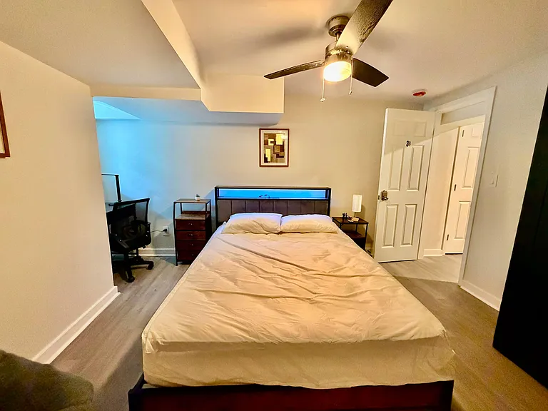 Private bedroom with a full bed, ceiling fan, and convenient bedside tables, plus a desk nook for work or study.