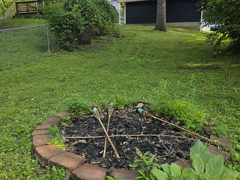 Very Large Yard with Fire Pit. Yard has a fenced in area.