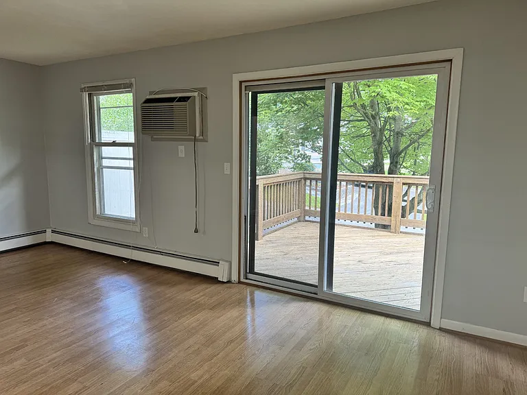 Living room with sliding glass door to large back deck.