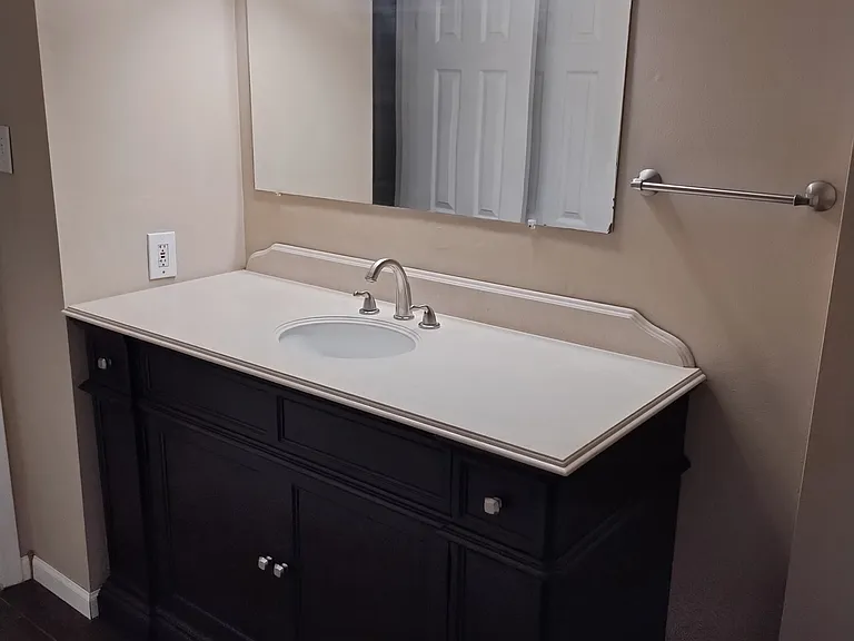 Vanity of Front Bathroom shown from bathtub.