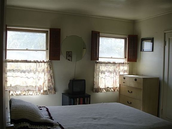 bedroom w/ two view windows