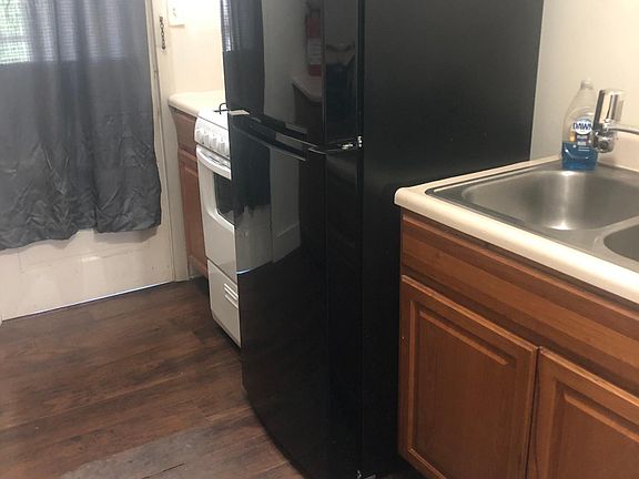 View of kitchen with new gas stove and refrigerator