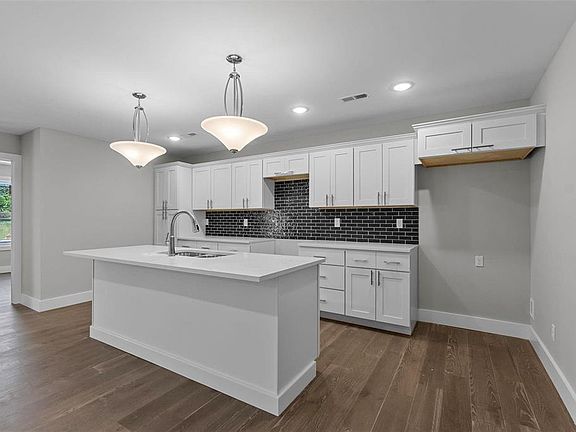 Spacious Kitchen with large island. Quartz countertops.