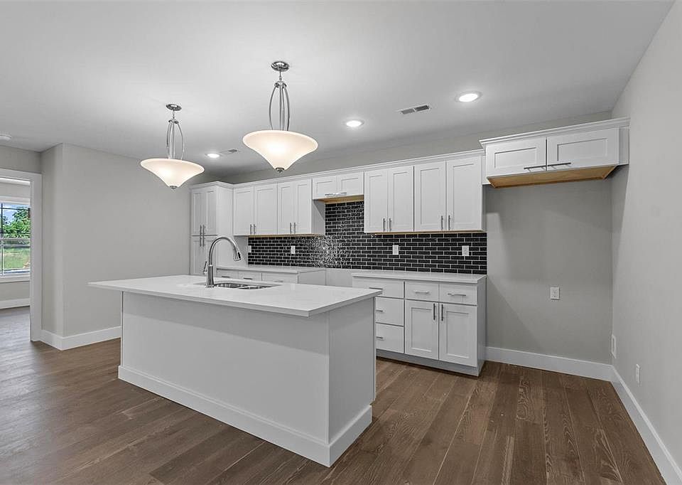 Spacious Kitchen with large island. Quartz countertops.