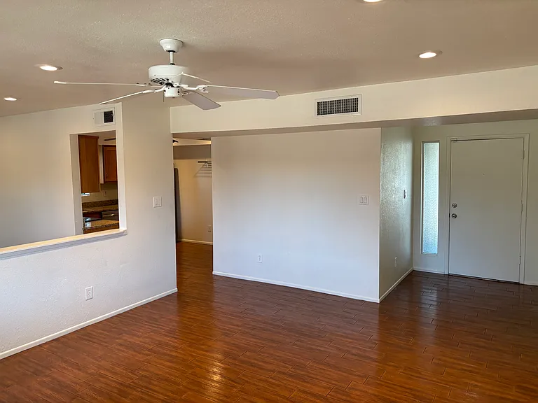 Living room showing kitchen and entrance.