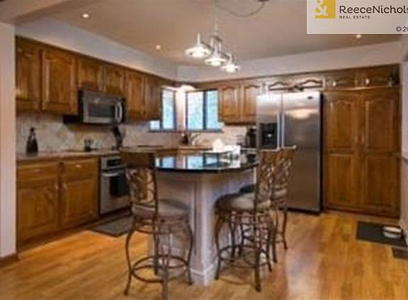 Updated Kitchen with Granite, Laminate Hardwoods, Island Seating
