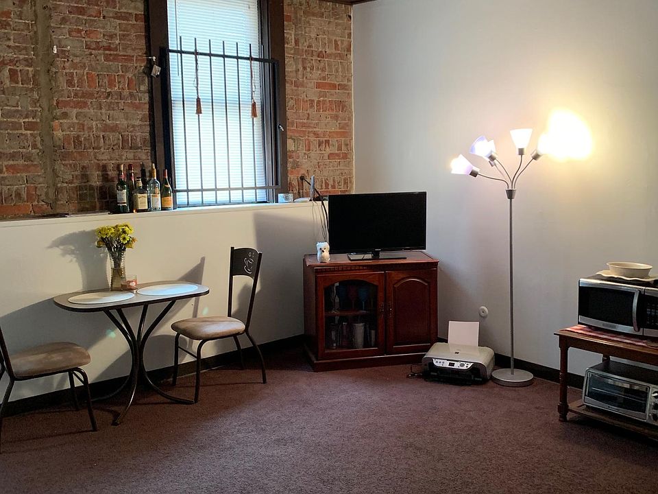 Large living/dining room with wood and brick accents