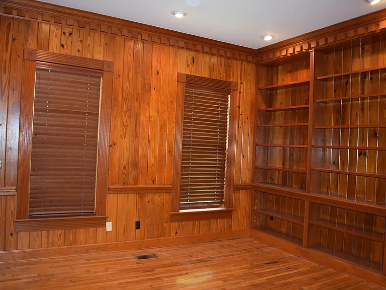 Office or 5th bedroom.... doors open to foyer and den. Includes closet and hand crafted moulding. Flooring came from the "Boys Colony" re-purposed and re-finsihed. Wood is over 100 years old at least....