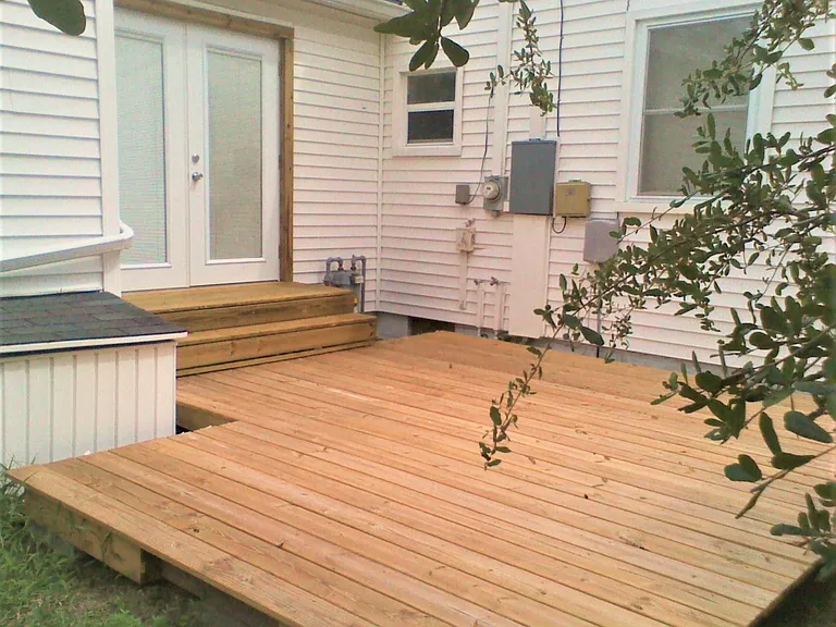 Backyard is fenced in with deck.