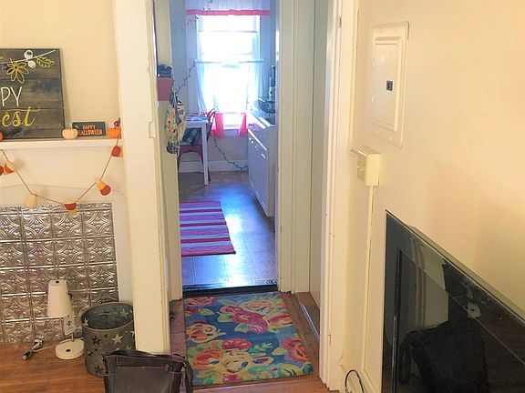 Standing in the living room, looking through to the kitchen.