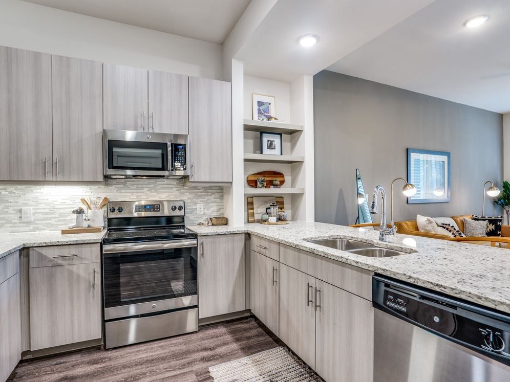 Gray finish package kitchen and dining area with hard surface flooring.