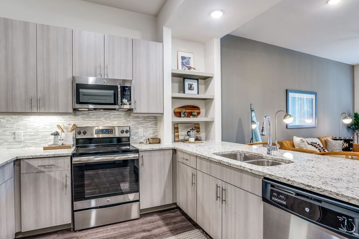 Gray finish package kitchen and dining area with hard surface flooring.