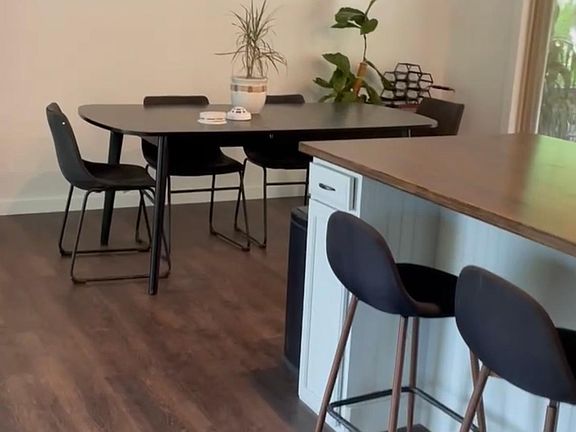 Extendable kitchen table and door that opens to a large porch.