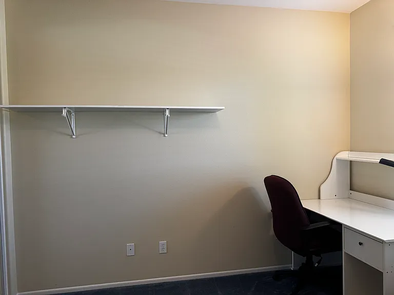 Bedroom #2 desk, desk chair, and wall shelf
