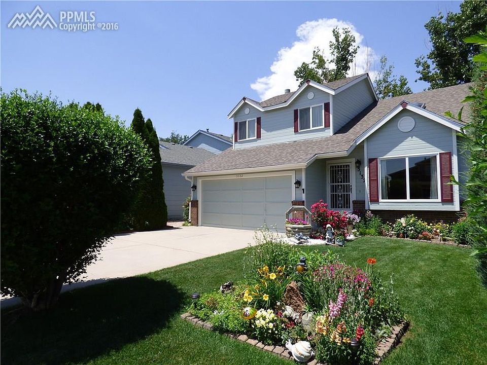 Front of home with beautiful mature landscaping