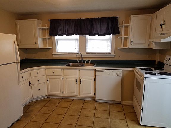 Large kitchen with dishwasher, stove and frig.